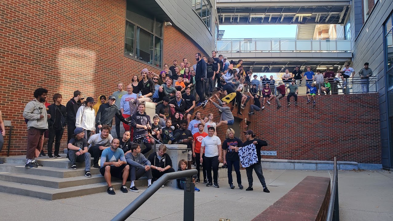 CincyJam participants gathered on outdoor steps and around brick walls in Cincinnati.