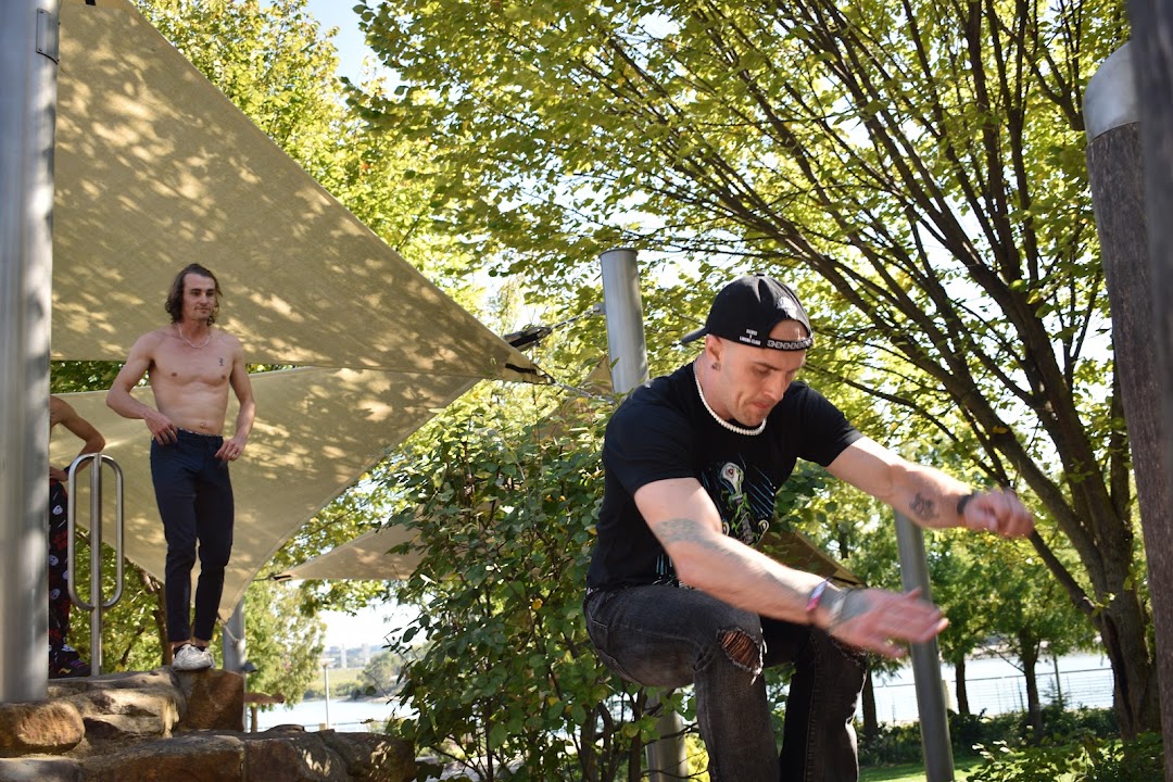 An adult participant moving outdoors beneath the trees at CincyJam.