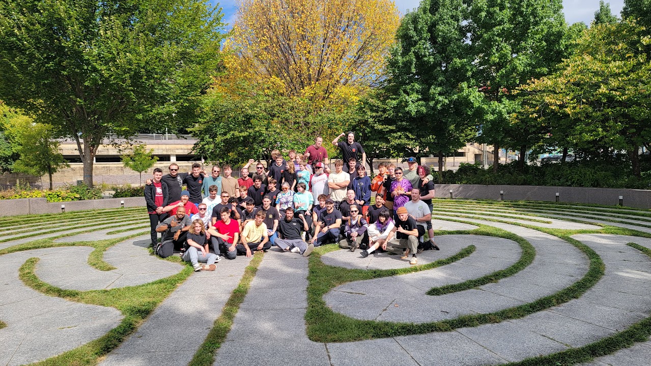 CincyJam participants of different ages gathered on curved outdoor steps in Cincinnati.